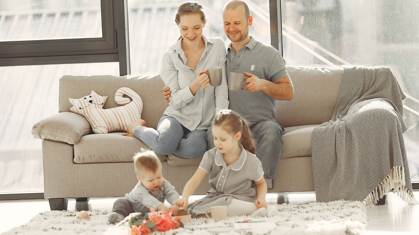 A family relaxing on a bright, spotless sofa