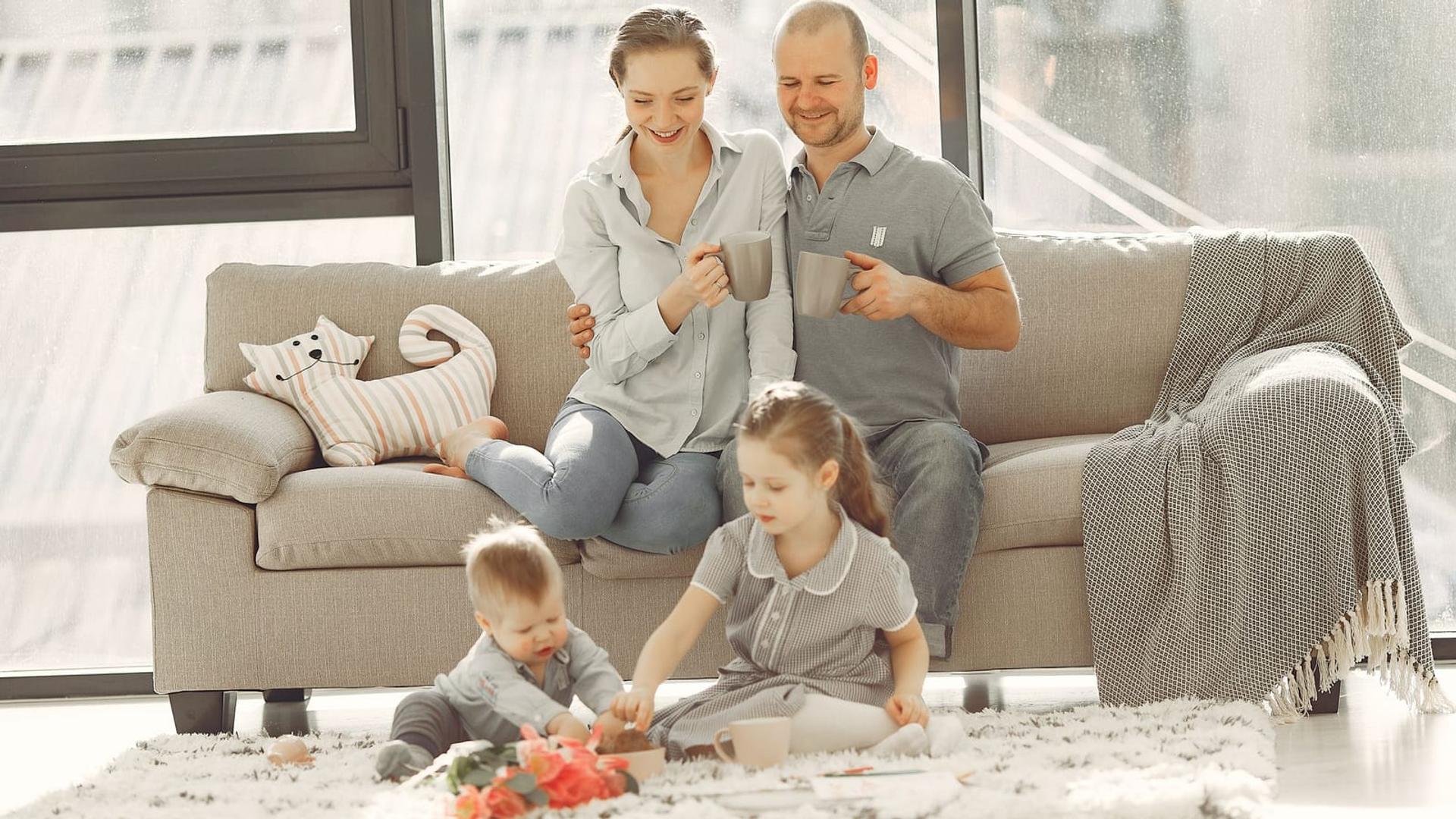 A family relaxing on a bright, spotless sofa
