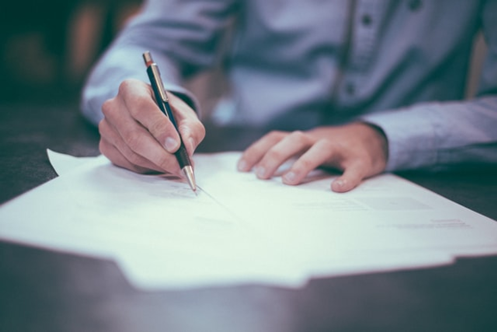 A person signing paperwork