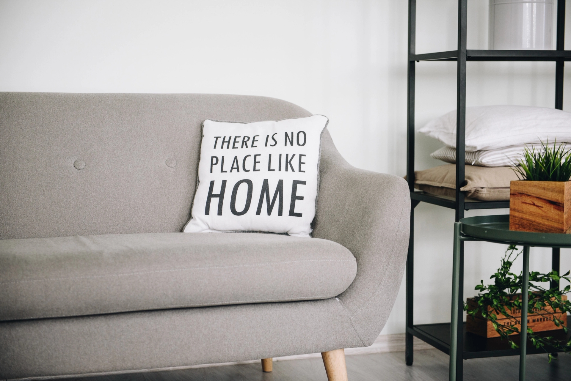 Sofa with cushion reading 'there is no place like home'