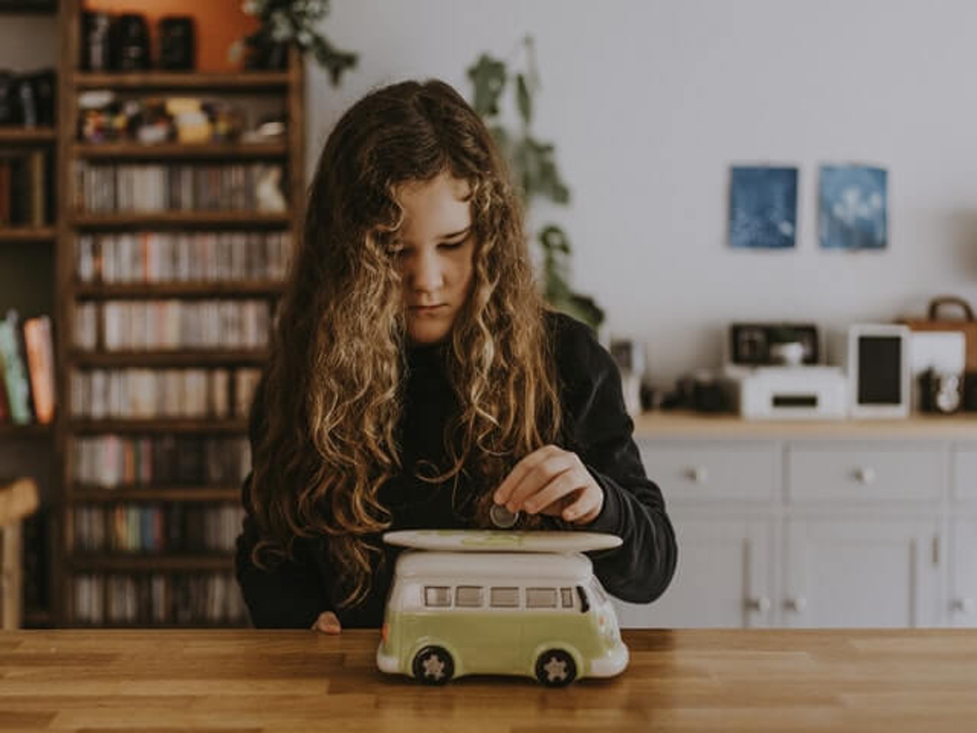 Girl putting money in a money box