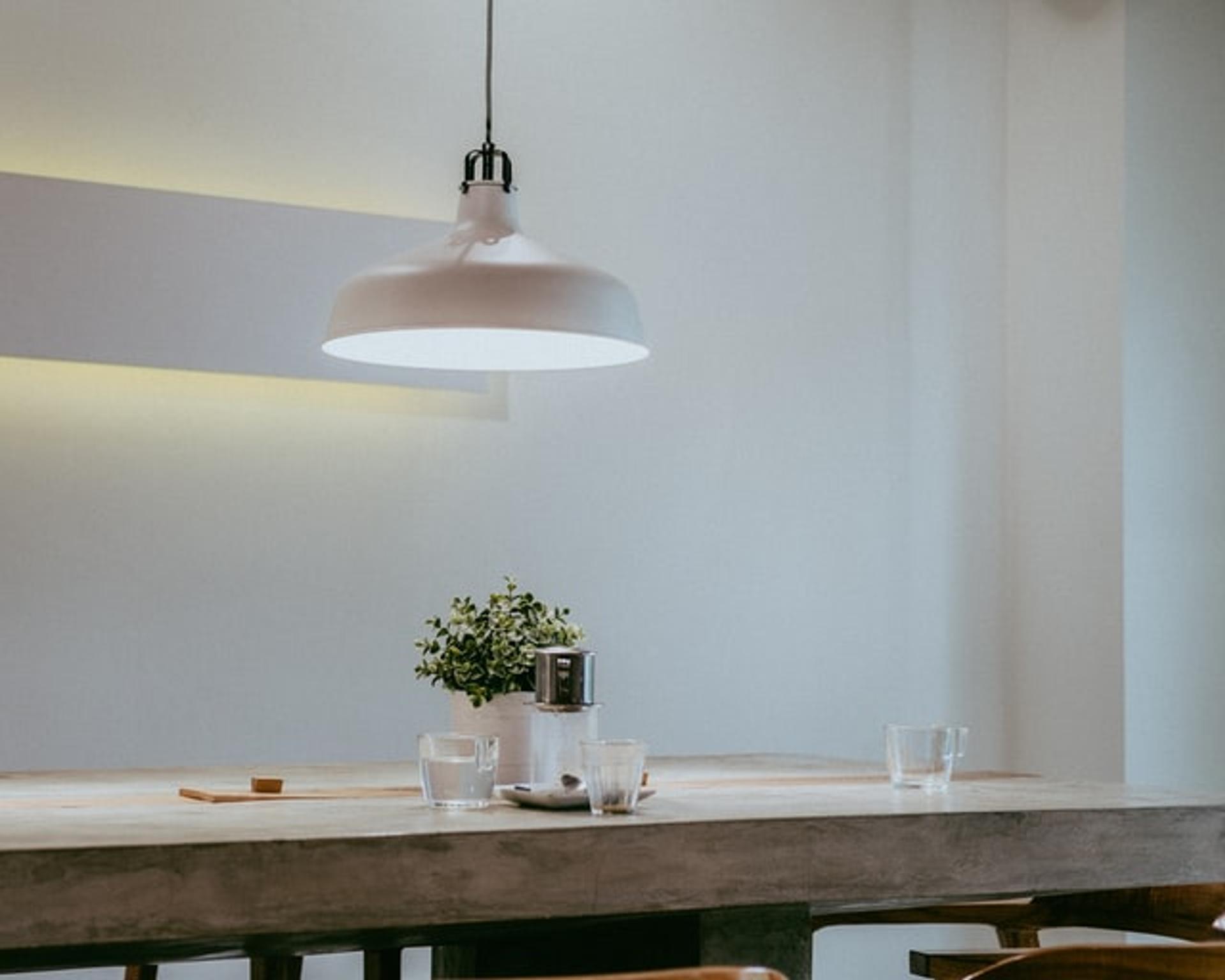 Large kitchen light over dining room table with paperwork.