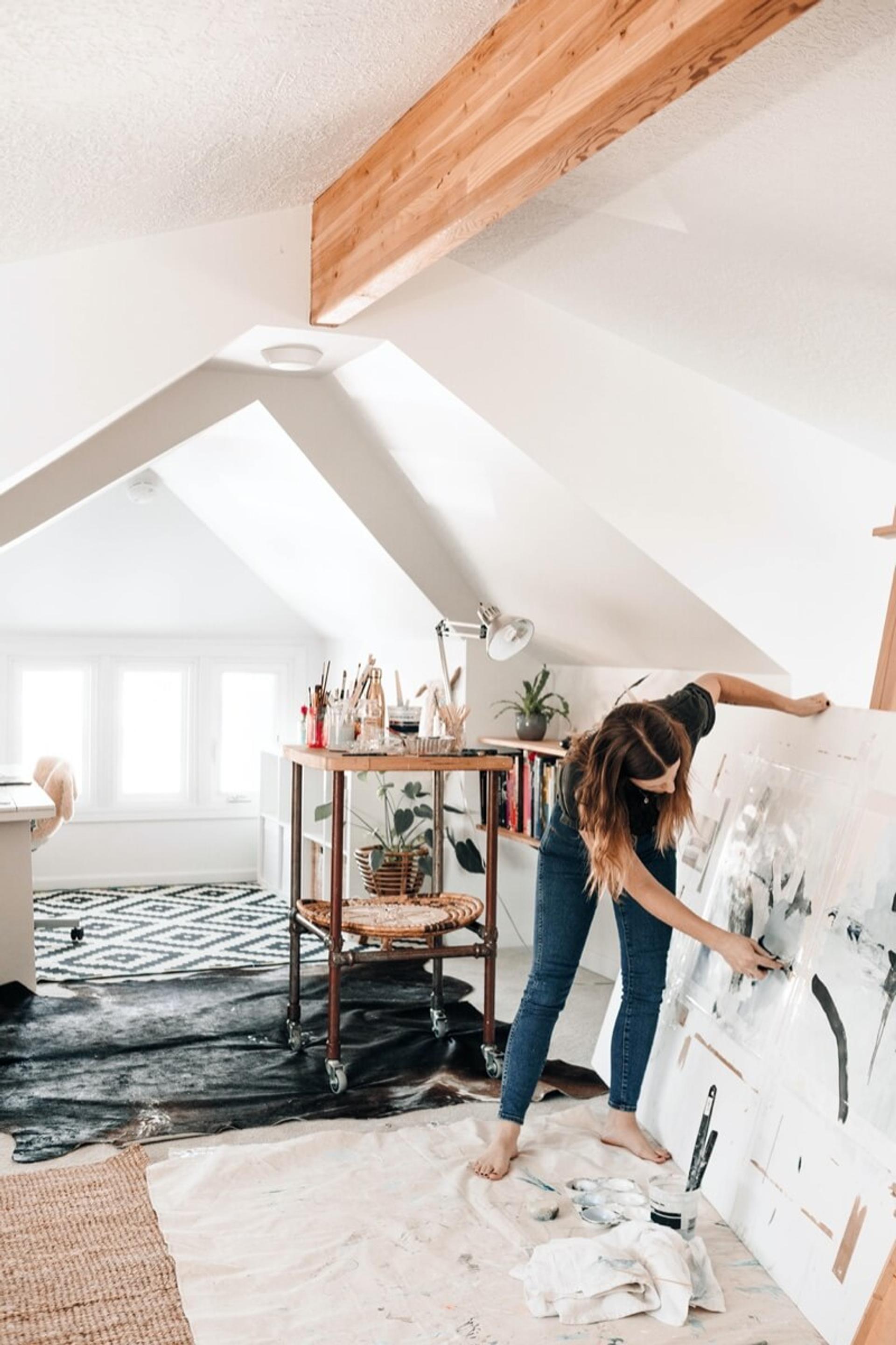 Girl with creative mood boards in light, bright attic studio