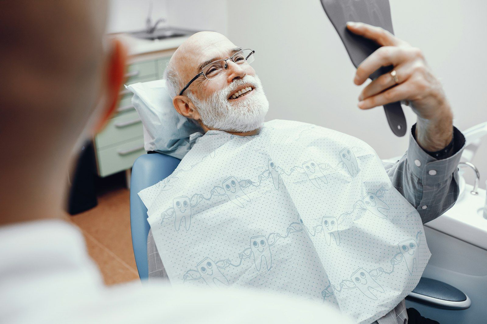 All-on-4 patient reviewing dental work with her dentist