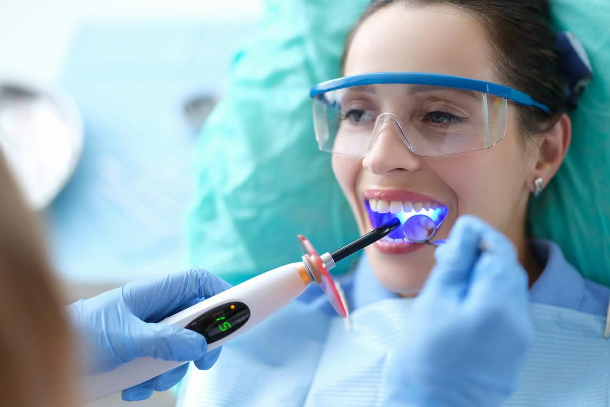 Smiling patient in the dental chair after a teeth whitening treatment at Bell Dental