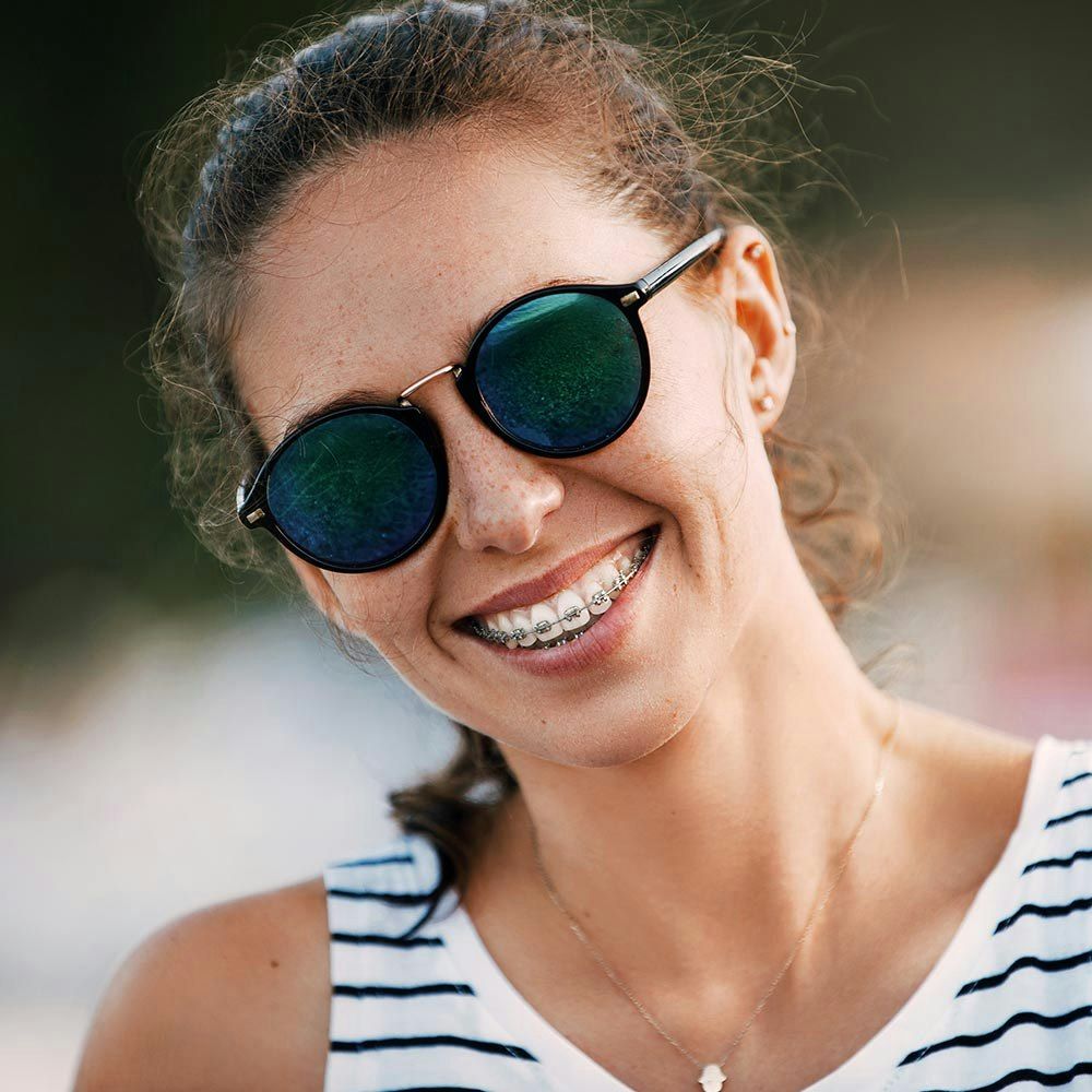 Close up of young woman smiling with braces