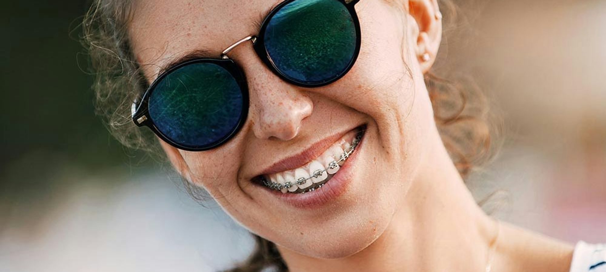 Close up of young woman smiling with braces