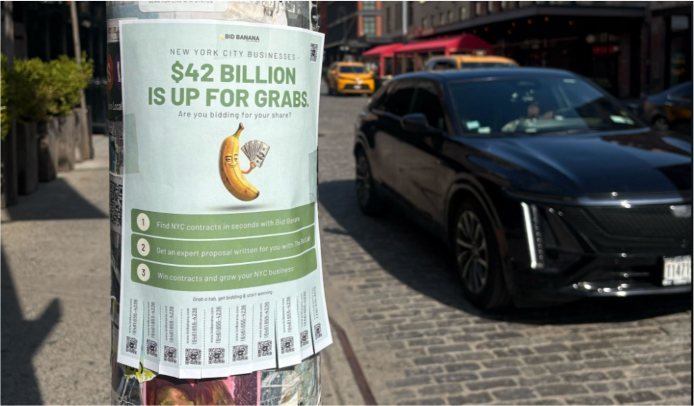 A Bid Banana flyer taped to a Manhattan lamppost reading “New York City businesses: $42 billion is up for grabs,” with a cartoon banana holding cash and tear-off QR code tabs.