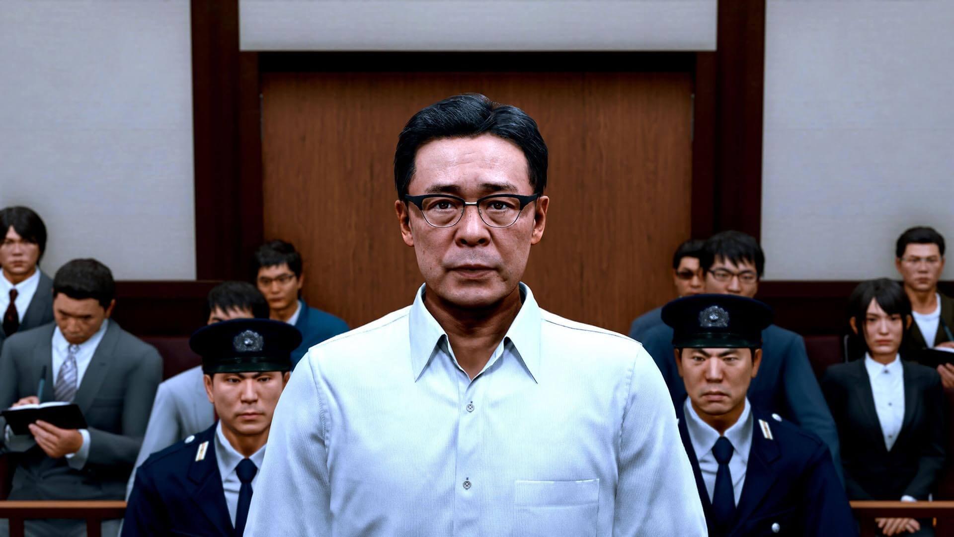Akihiro Ehara, a man in glasses and a white shirt, stands in a courtroom between two uniformed officers with the public gallery behind him