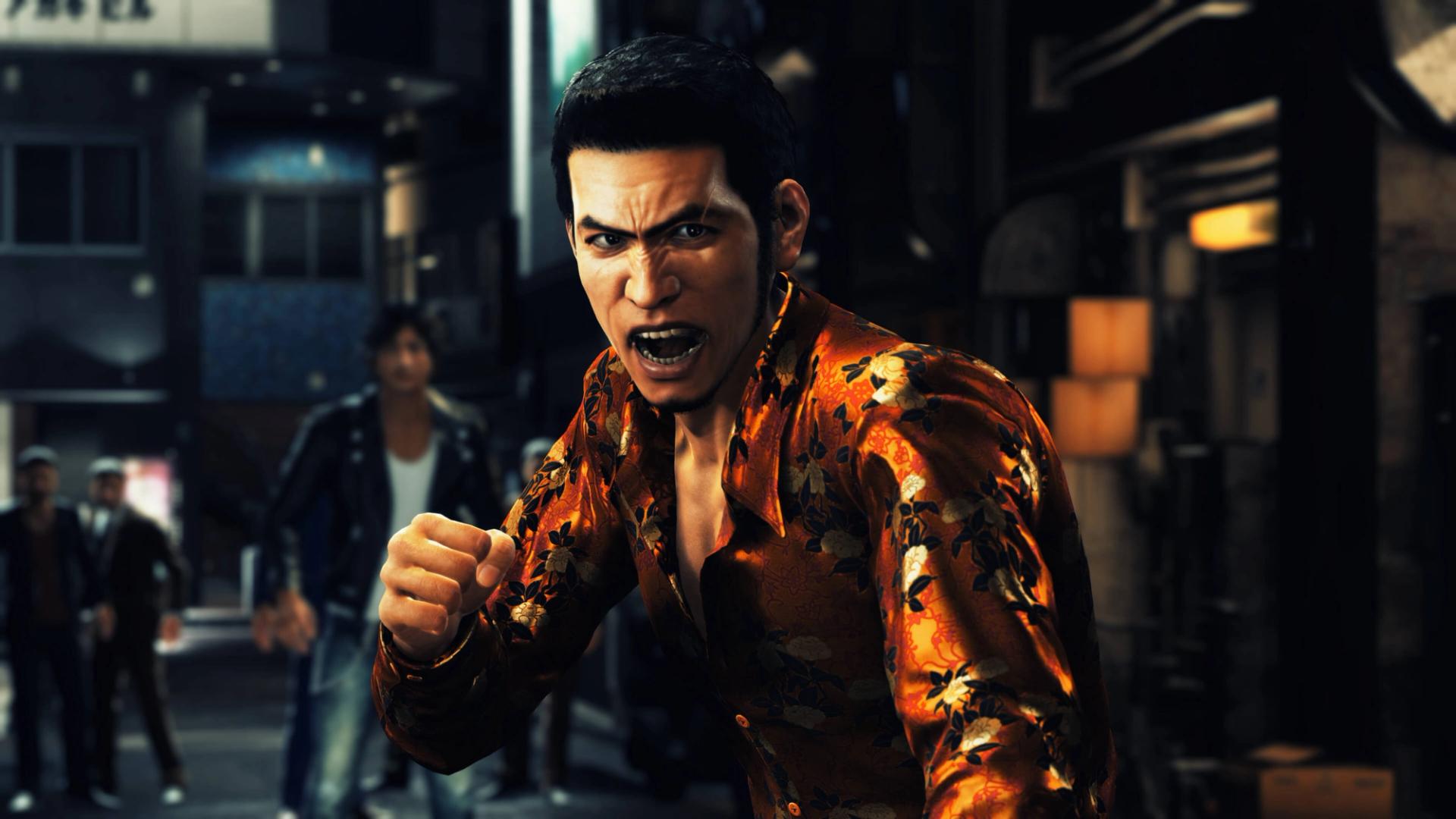 Masaharu Kaito in an orange floral shirt shouts with a raised fist on a Kamurocho street at night, with Yagami standing behind him