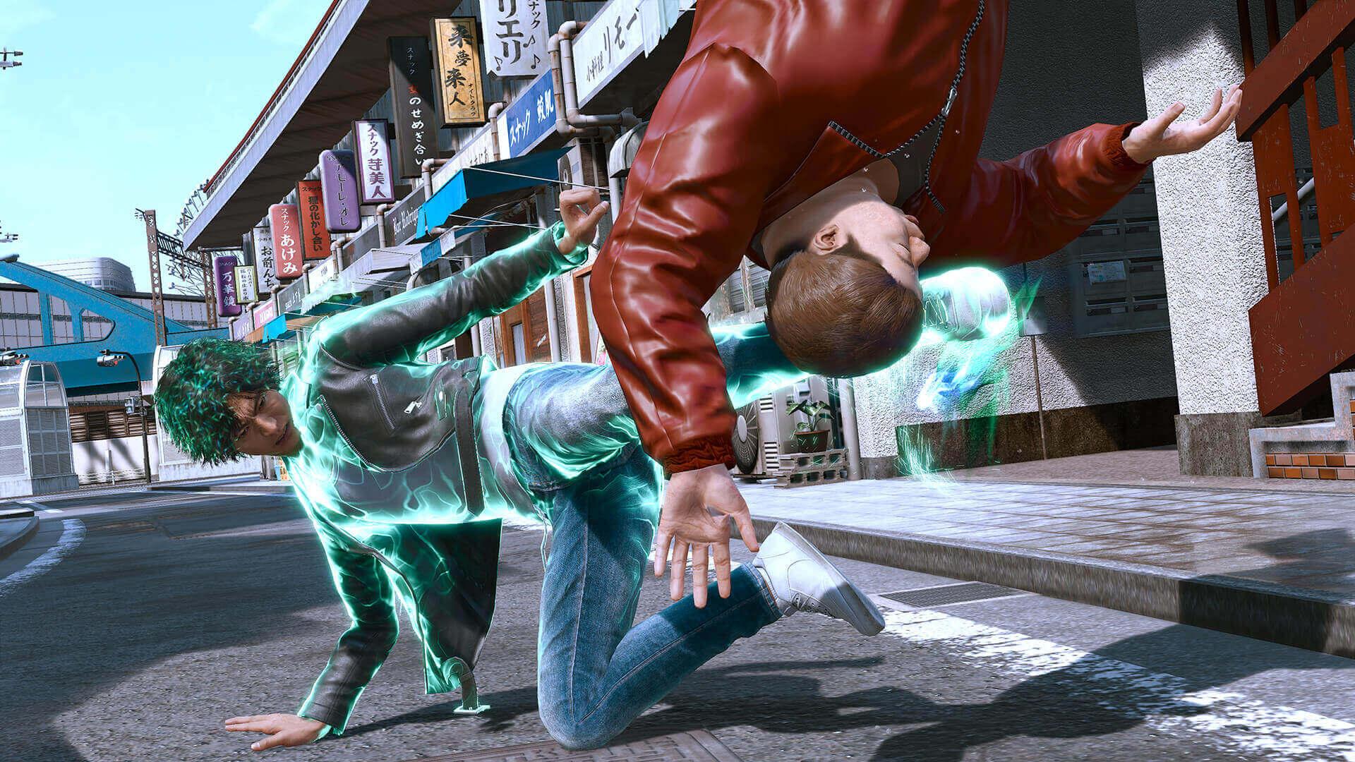 Yagami, glowing with a teal aura, crouches and flips a man in a red leather jacket over his shoulder on a shopping street