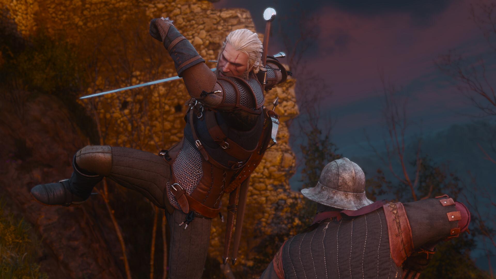 Geralt leaps mid-spin with his steel sword drawn above a soldier in a kettle helmet, beside a ruined stone tower at dusk.