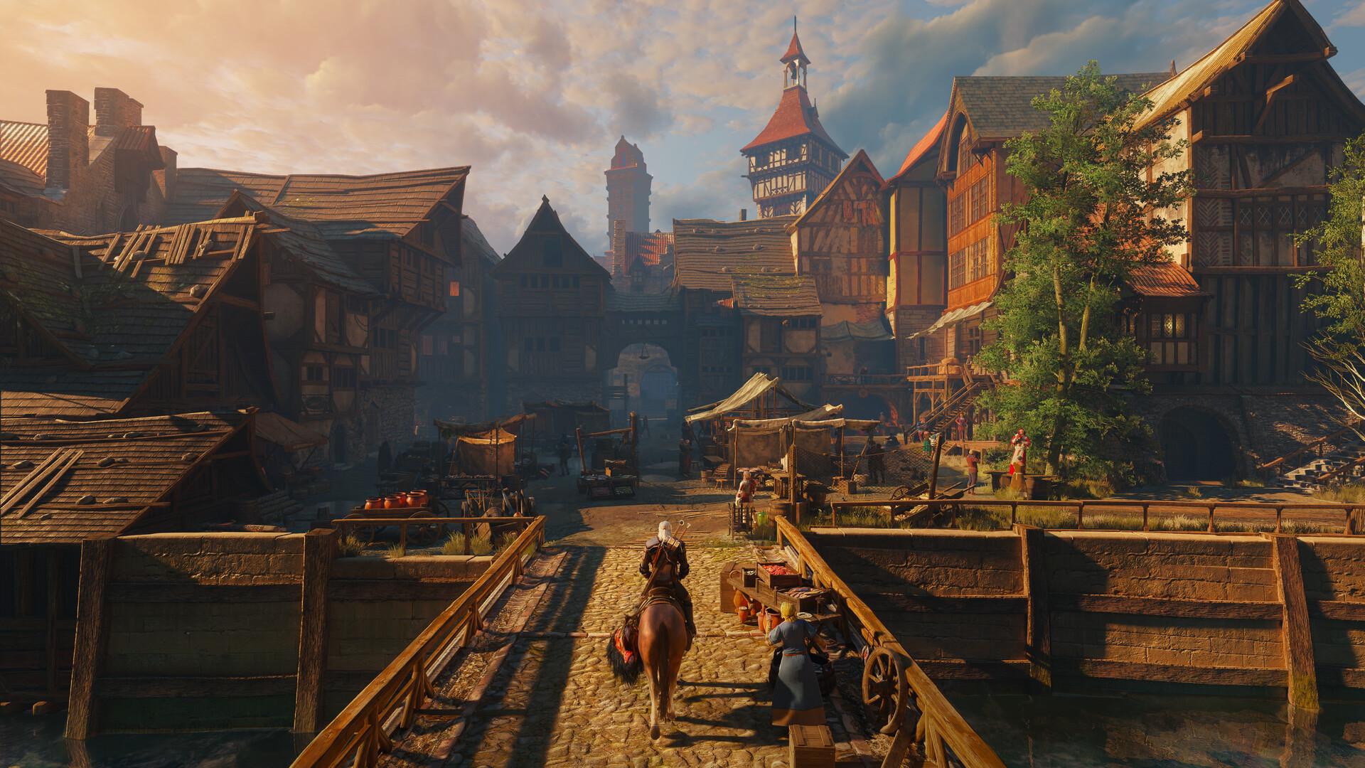 Geralt rides his horse Roach across a wooden bridge into a town of tall half-timbered houses and market stalls under a clouded evening sky.