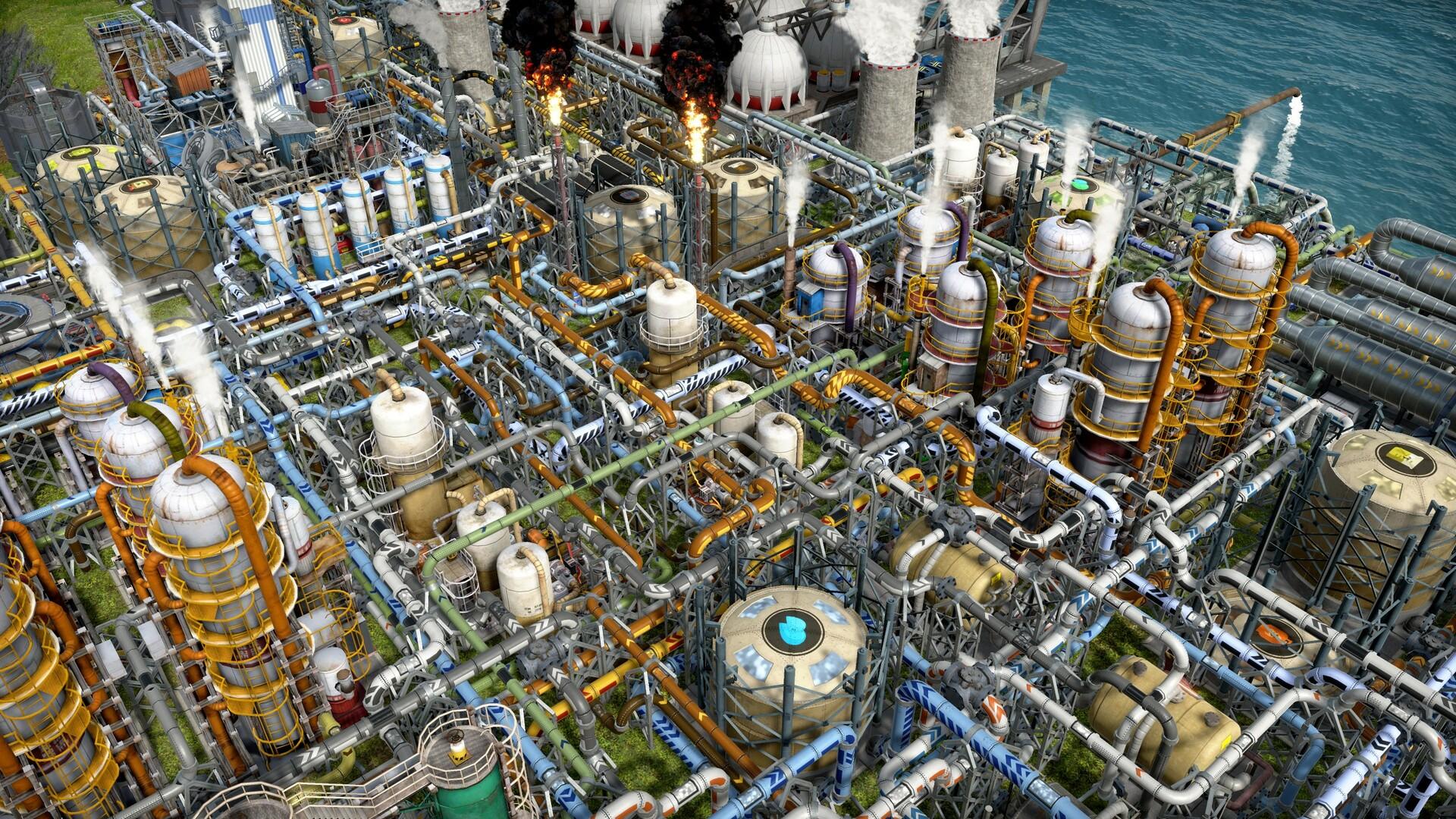 A dense oil refinery in Captain of Industry, with distillation towers, storage tanks and layers of colour-coded pipes stacked over each other, two flare stacks burning with black smoke and cooling towers at the edge of the sea.