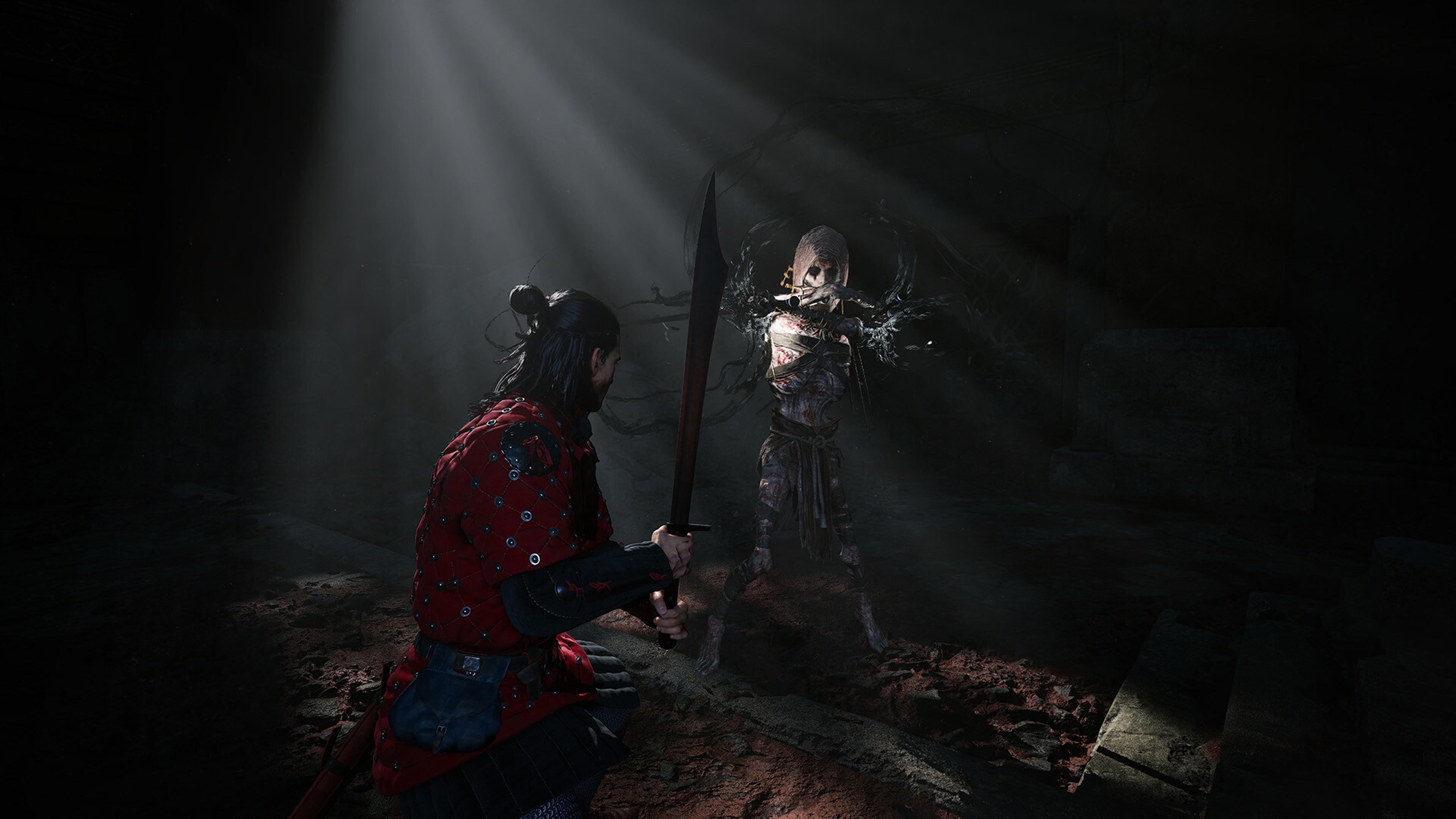 Coen crouched with a drawn sword facing a pale creature of the night in a dark crypt lit by a shaft of light