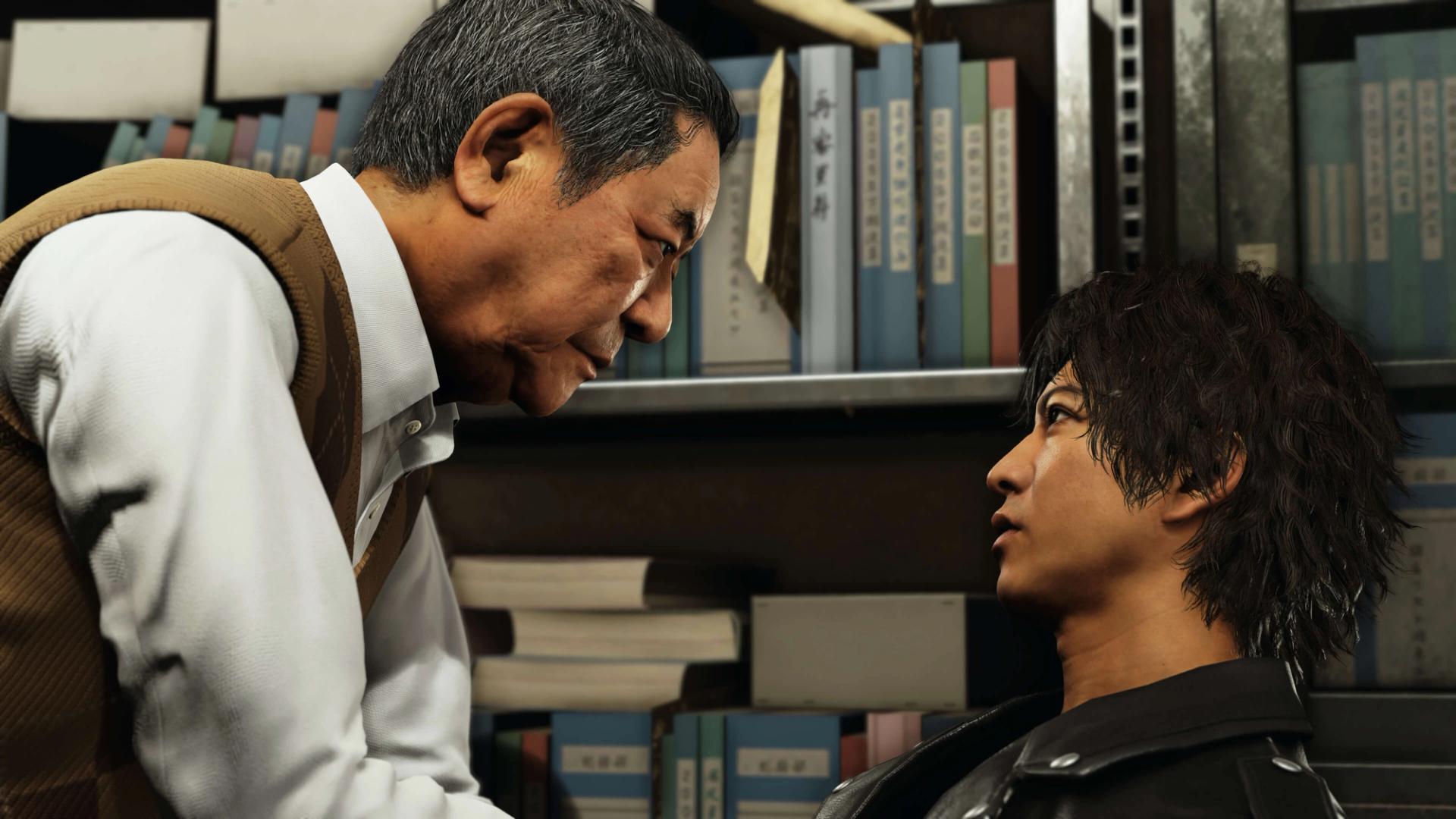 Ryuzo Genda, an older man in a brown argyle vest, leans in close to Takayuki Yagami in front of shelves of legal files