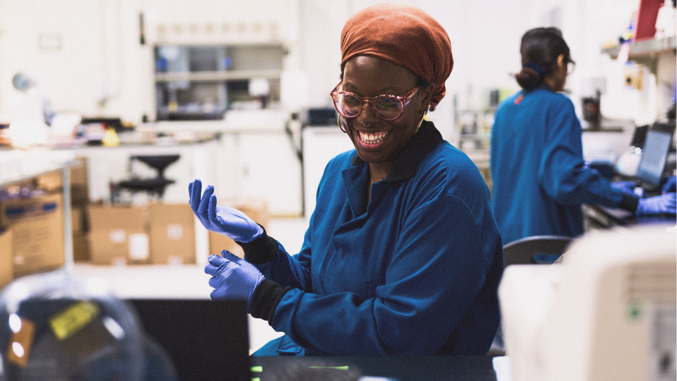 Person working wearing gloves and smiling