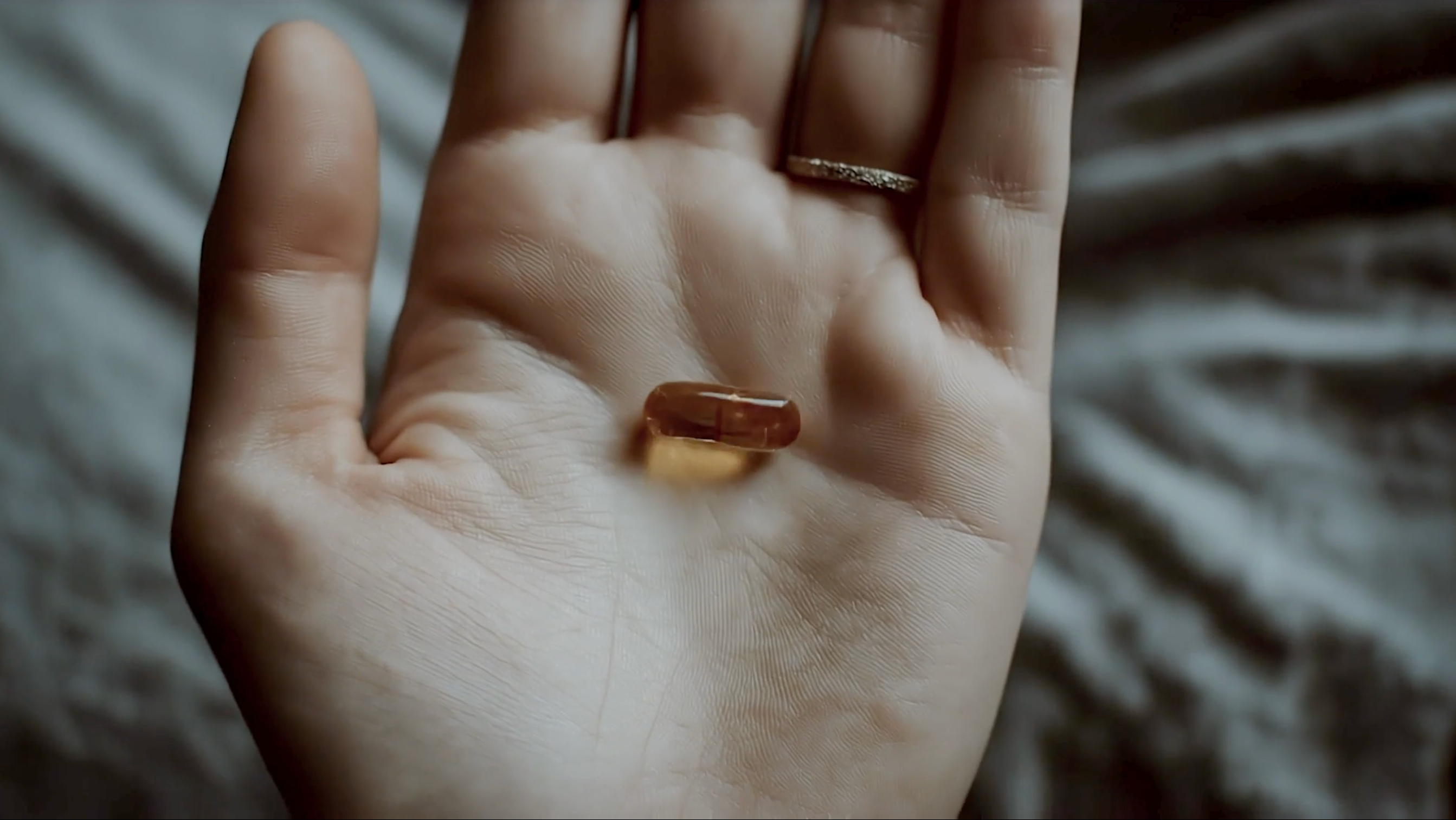 A pill in the palm of a hand