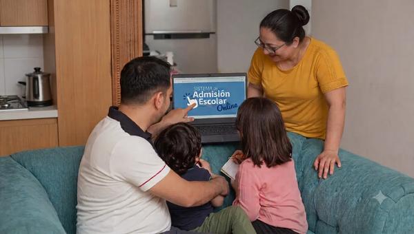 Familia compuesta por cuatro personas: un hombre, una mujer, un niño y una niña. Están viendo un computador que muestra la portada del Sistema de Admisión Escolar (SAE)