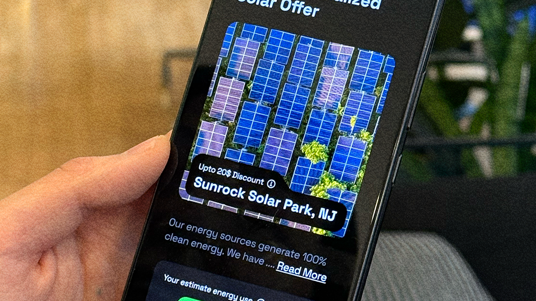A person holds a smartphone displaying a personalized solar energy offer for Sunrock Solar Park in New Jersey, with an estimated monthly energy cost slider visible on the screen.