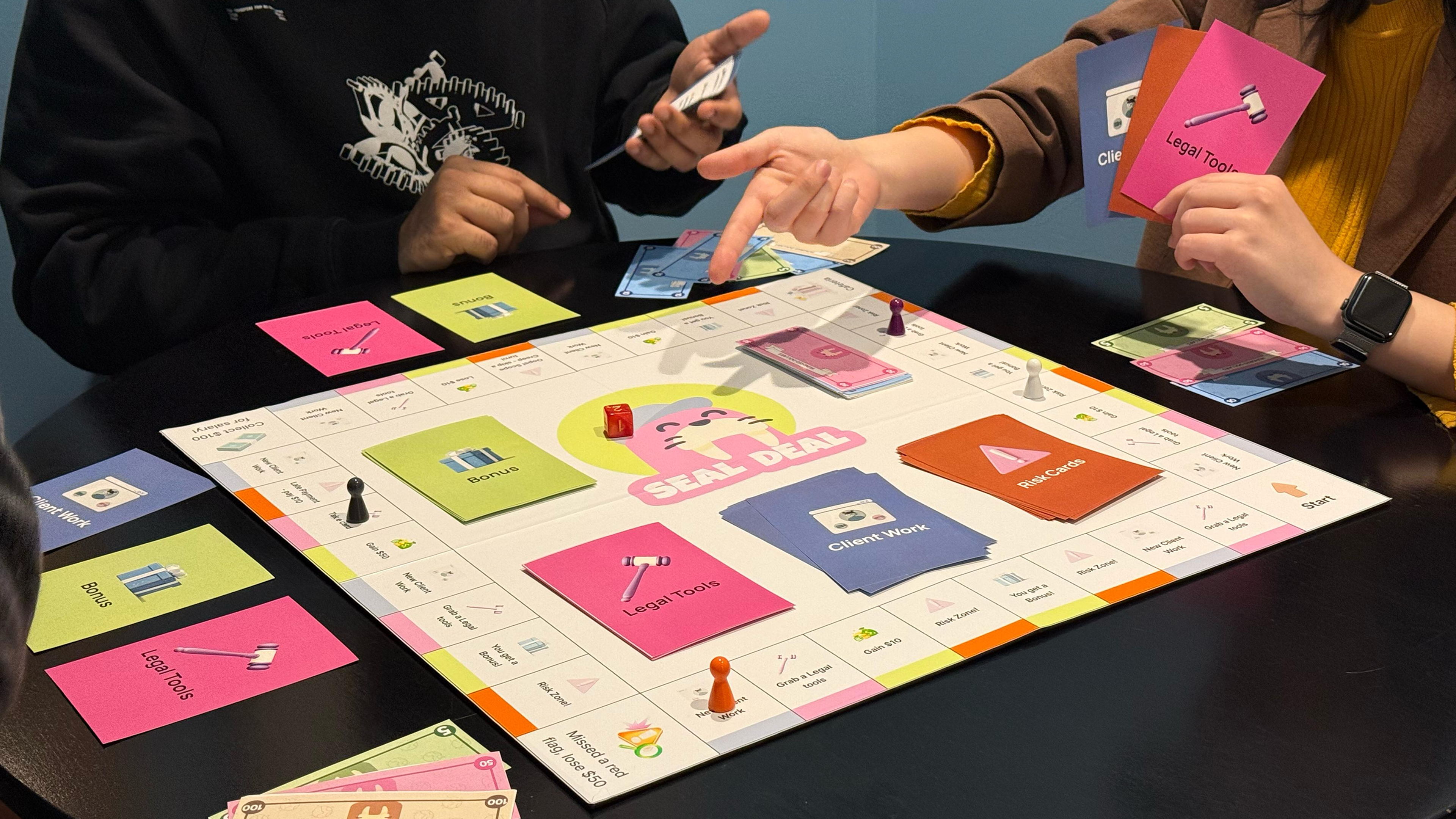 Colorful board game that gamifies freelancer contracts and legal jargon. 