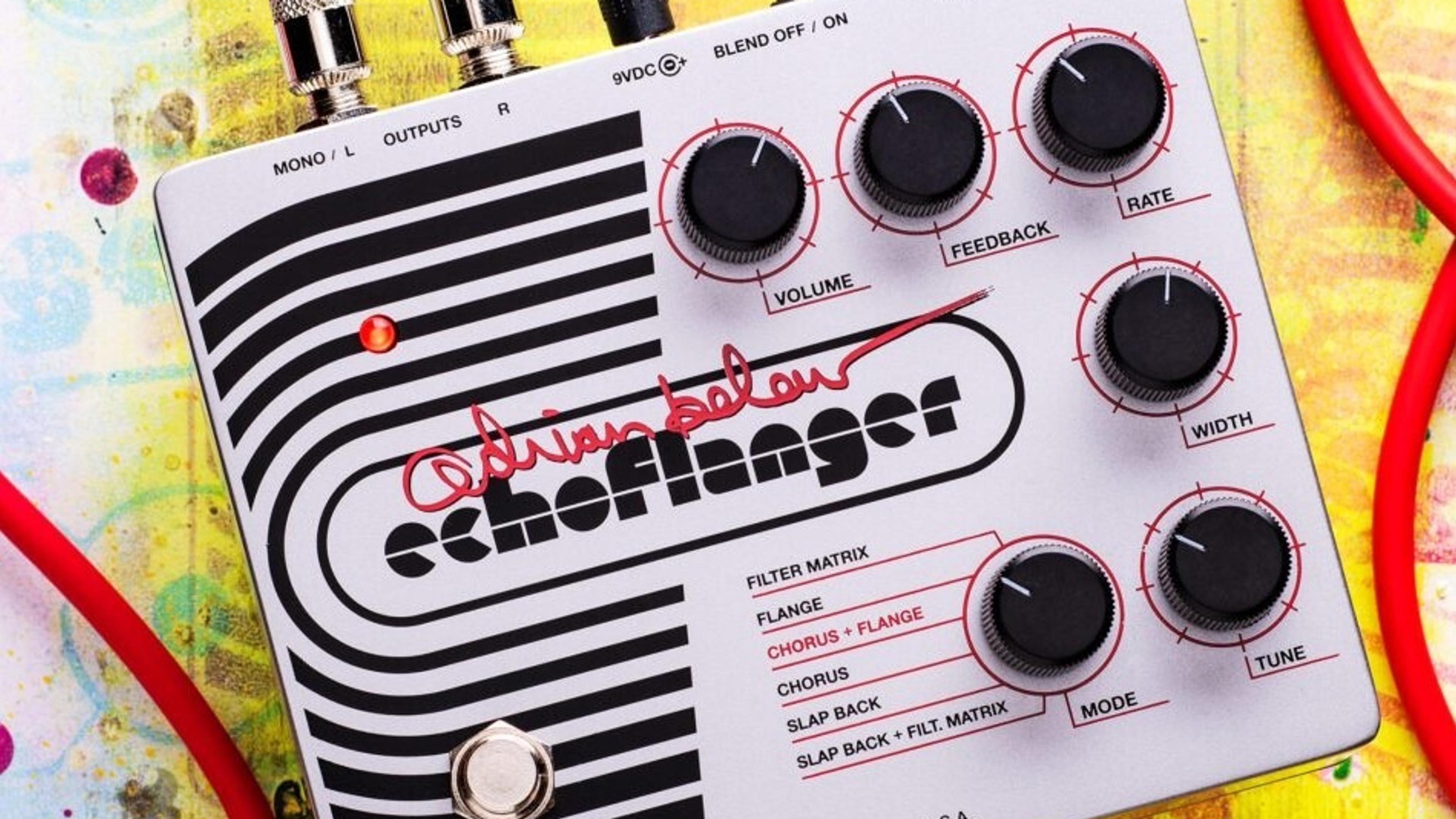 Electro-Harmonix Adrian Belew Echoflanger on a paint-splattered surface with red instrument cables plugged in