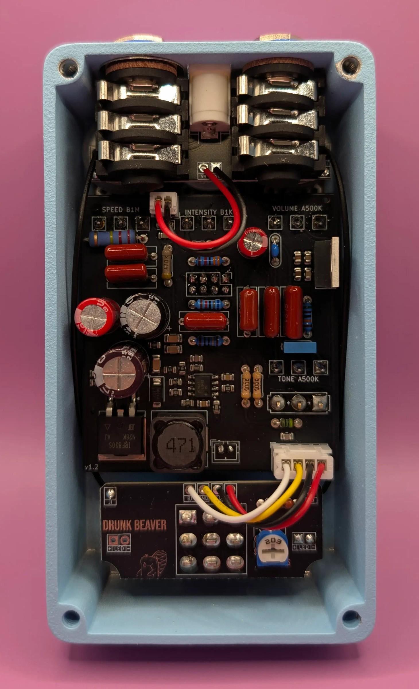 Drunk Beaver Kostiantynivka Dominator Preamp with the back plate off, circuit board, wiring and jacks inside the pale blue enclosure
