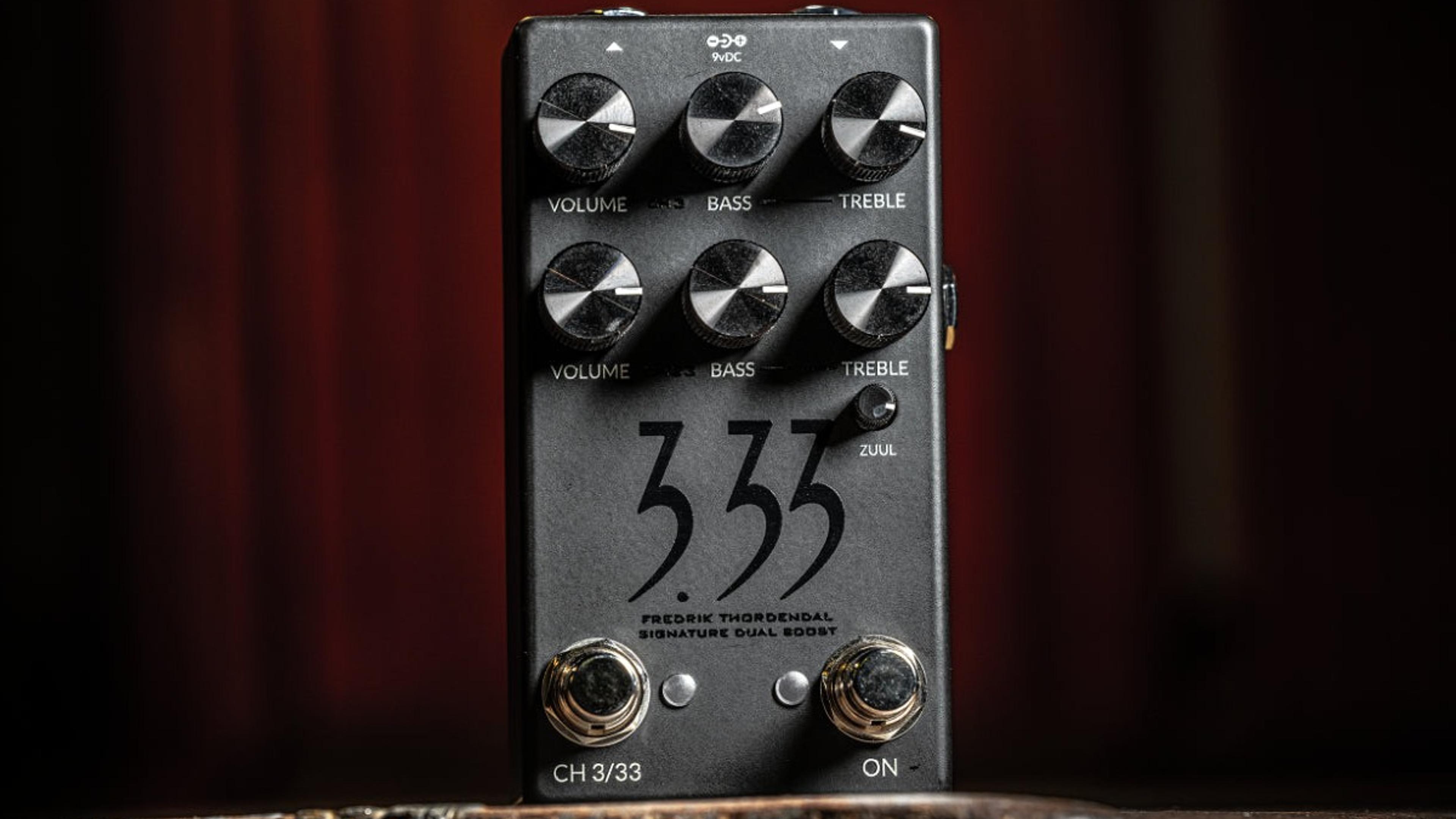 Fortin 3.33 standing on a weathered wooden block in front of a dark red curtain, two rows of Volume, Bass and Treble knobs above the 3.33 logo