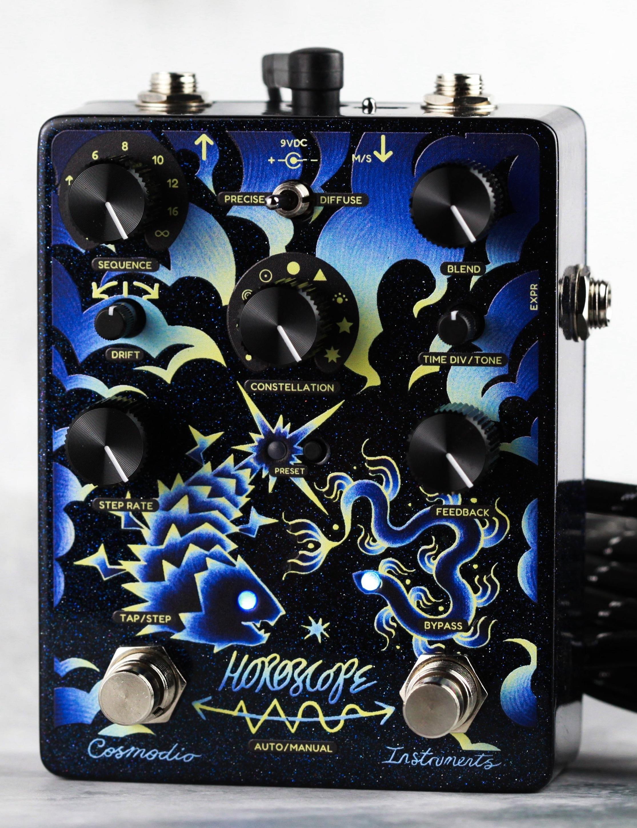 Cosmodio Horoscope, front view on a light grey backdrop, seven black knobs, Precise/Diffuse toggle, top jacks and two footswitches under blue and gold artwork