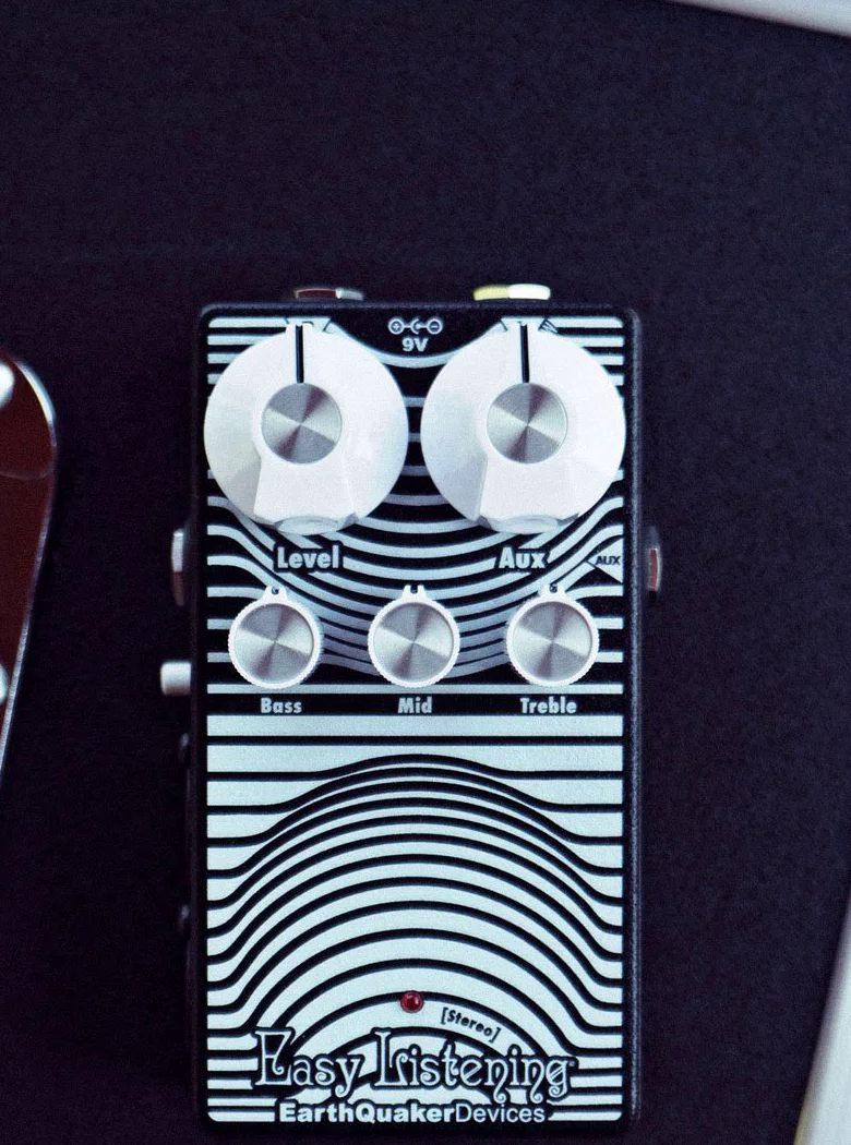 EarthQuaker Devices Stereo Easy Listening on a flight case, Level Aux and Bass Mid Treble knobs visible