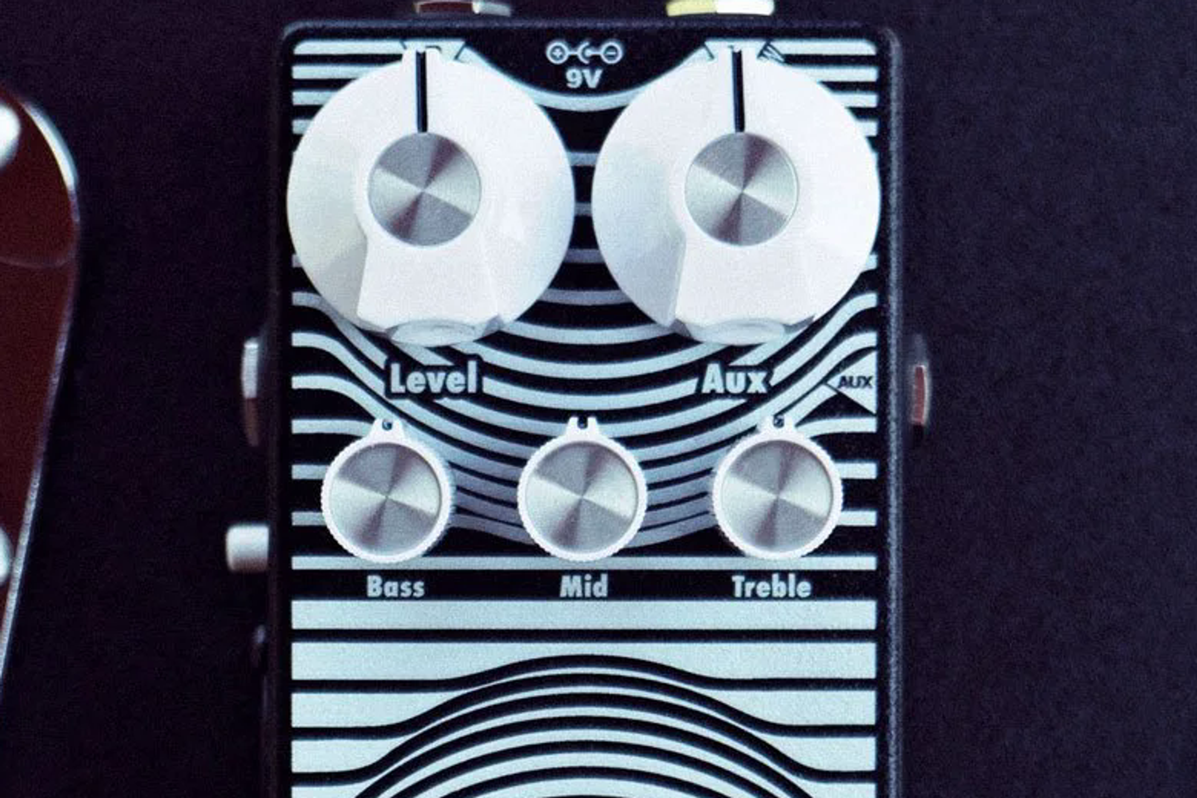 EarthQuaker Devices Stereo Easy Listening on a flight case, Level Aux and Bass Mid Treble knobs visible