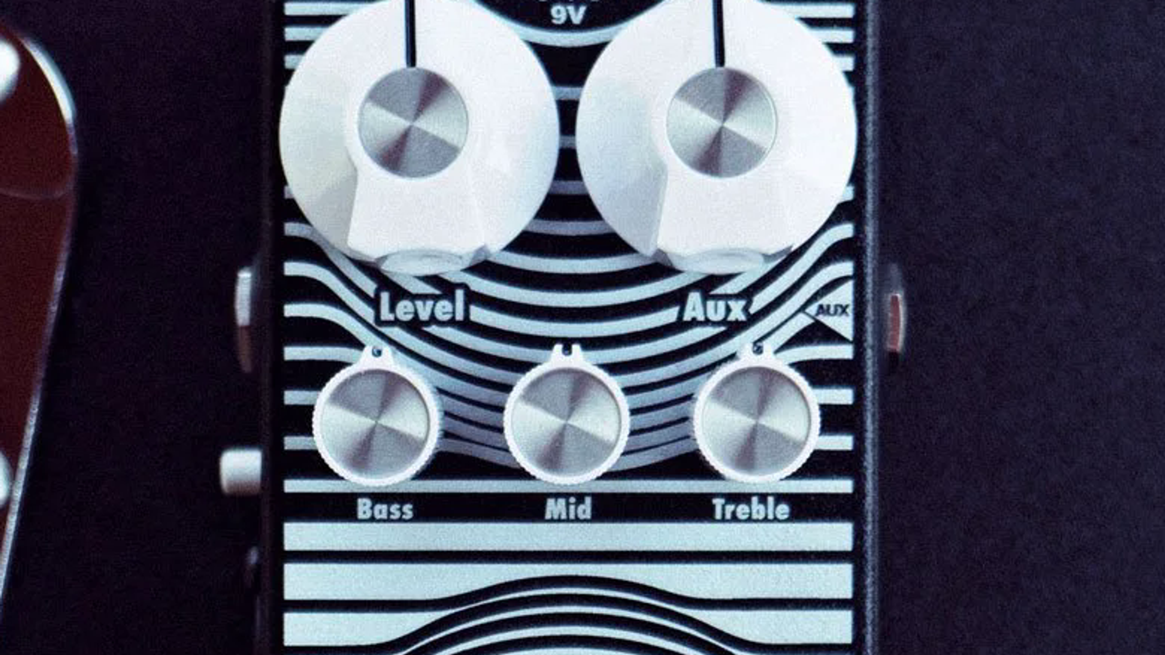 EarthQuaker Devices Stereo Easy Listening on a flight case, Level Aux and Bass Mid Treble knobs visible