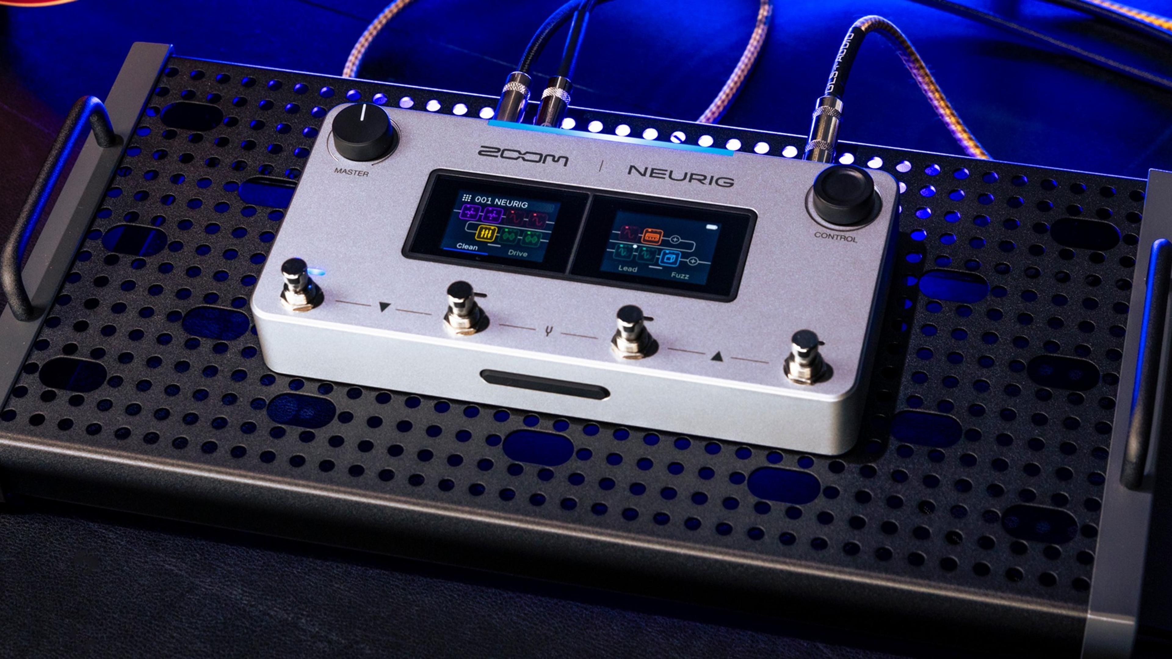 ZOOM NEURIG on a black perforated pedalboard under blue stage light, dual touchscreens lit and cables in the top jacks
