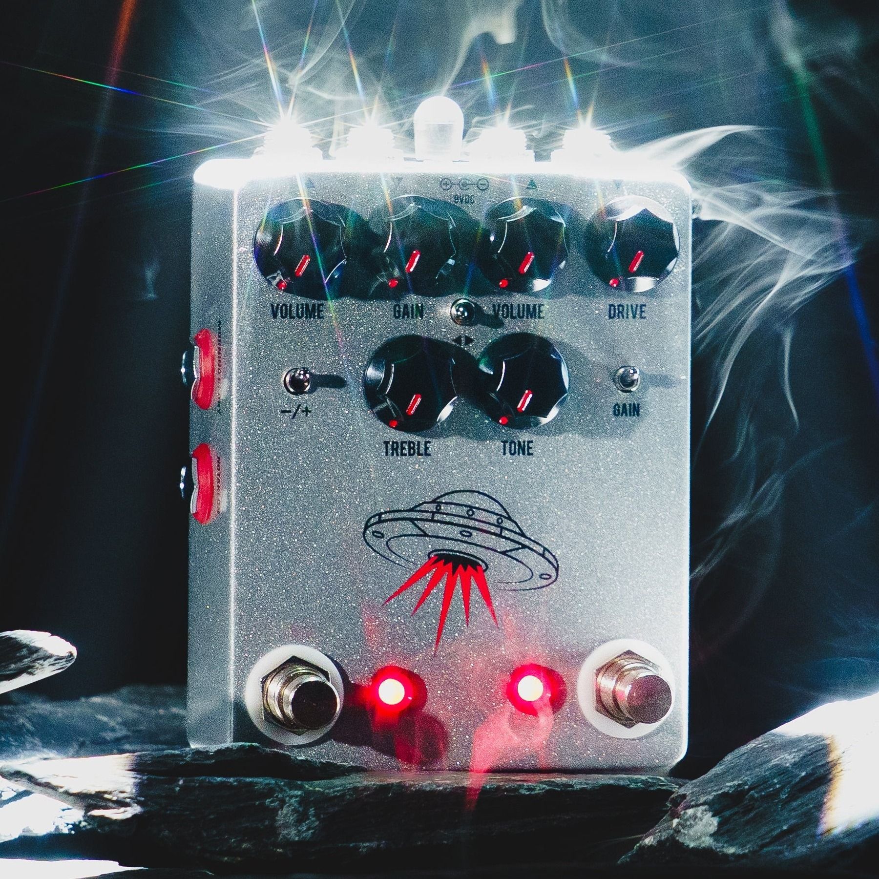 JHS Wanderer on dark slate under a white spotlight with drifting smoke, both LEDs lit red