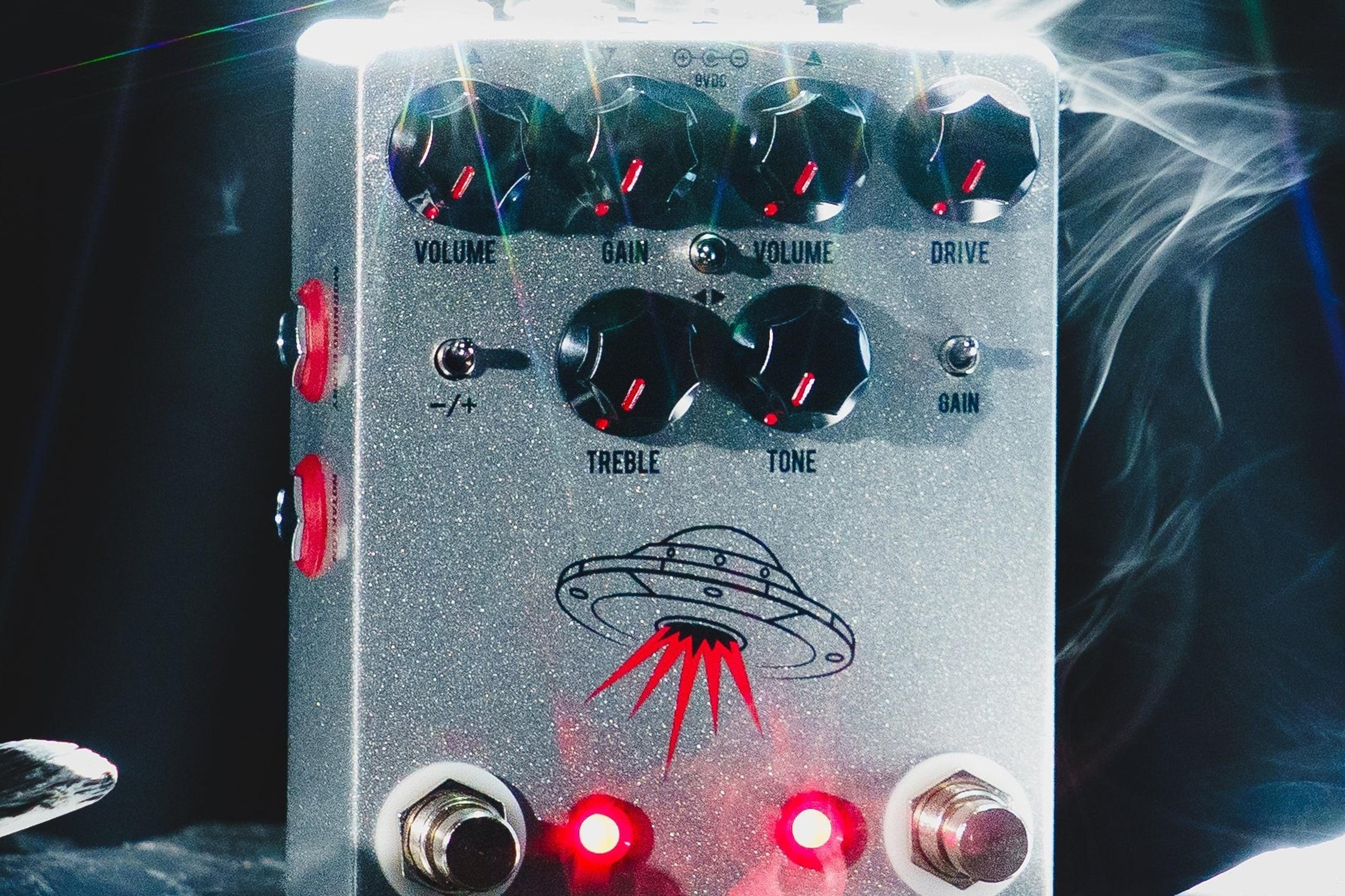JHS Wanderer on dark slate under a white spotlight with drifting smoke, both LEDs lit red