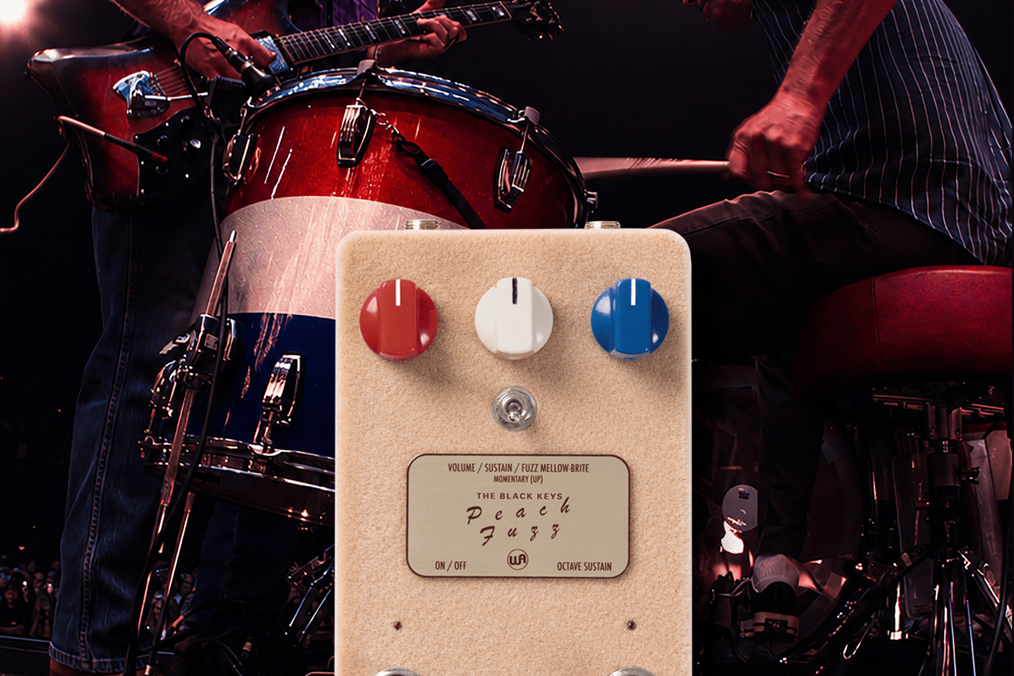 Warm Audio The Black Keys Peach Fuzz pedal in front of a live Black Keys stage scene