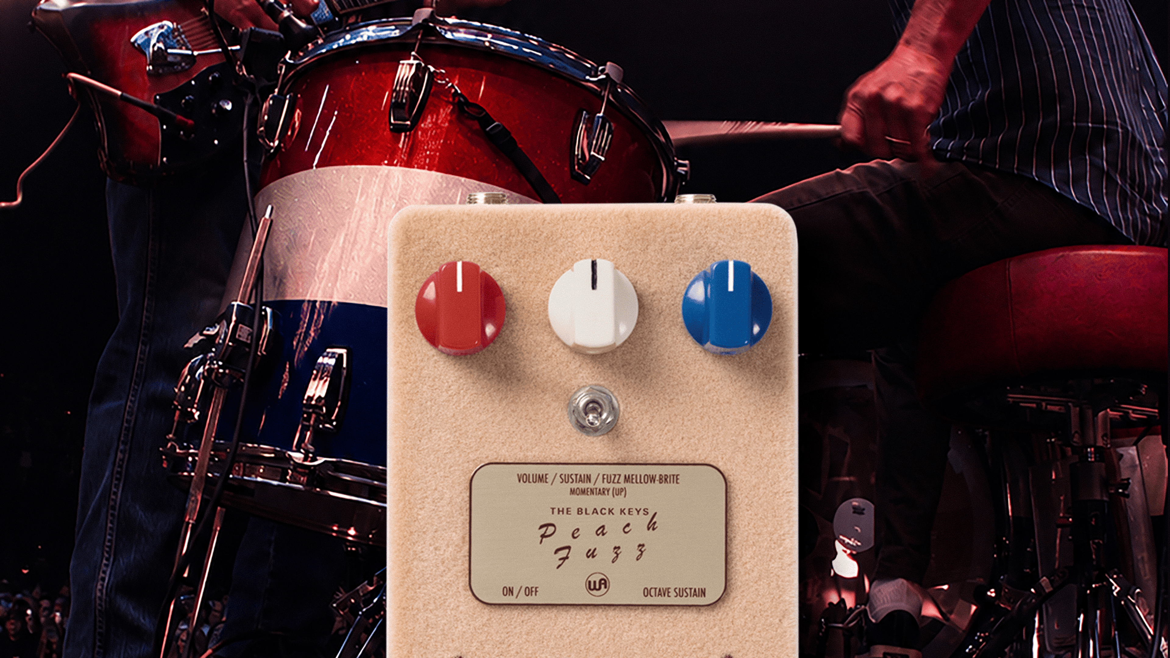 Warm Audio The Black Keys Peach Fuzz pedal in front of a live Black Keys stage scene