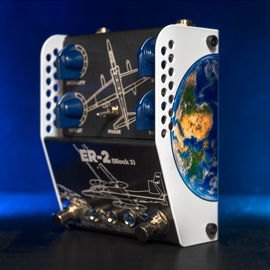 ThorpyFX ER-2 Block 3 seen from the side in blue light, black panel with blue knobs and aircraft line art, a Phase toggle and an Earth graphic on the white side panel