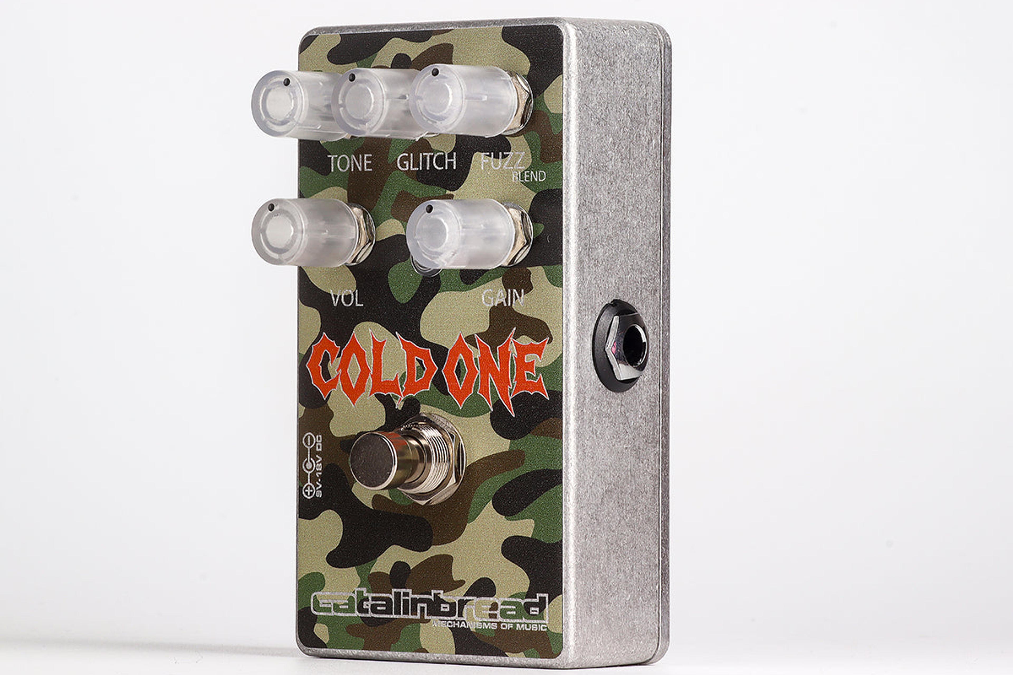 Catalinbread Cold One at an angle on a light grey background, green camouflage enclosure with five clear knobs and orange Cold One logo
