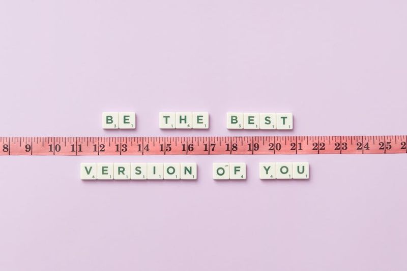 Motivational phrase 'Be the Best Version of You' with a measuring tape on purple background.