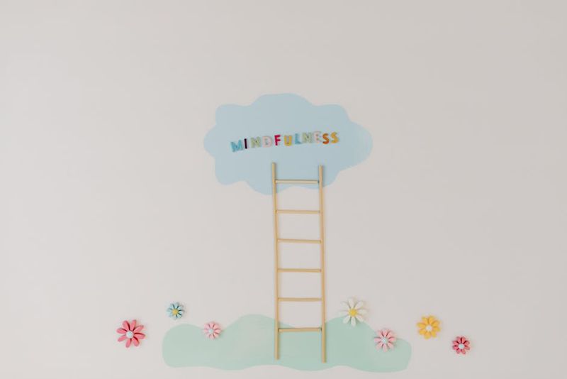 A minimalist conceptual art piece with a ladder leading to the word 'Mindfulness'.