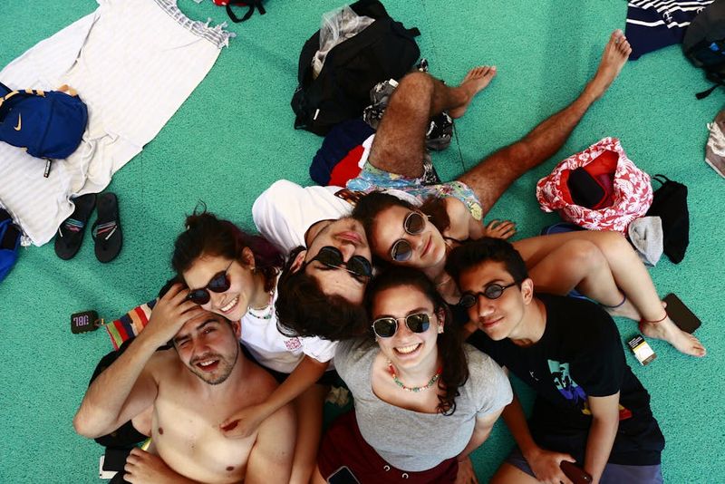 Group of friends enjoying a sunny day together, smiling and relaxed.