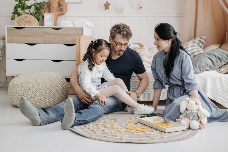 A family enjoying quality time together playing a board game in a cozy living room setting.