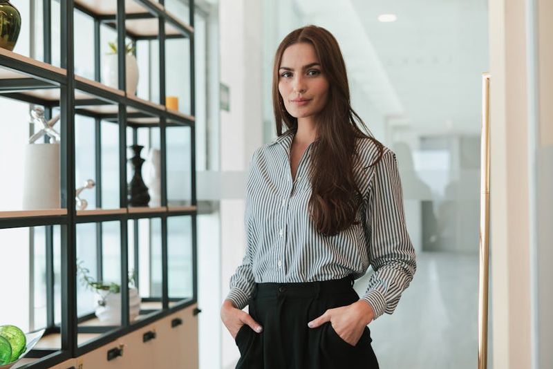 Portrait of a confident businesswoman standing in a modern office environment.