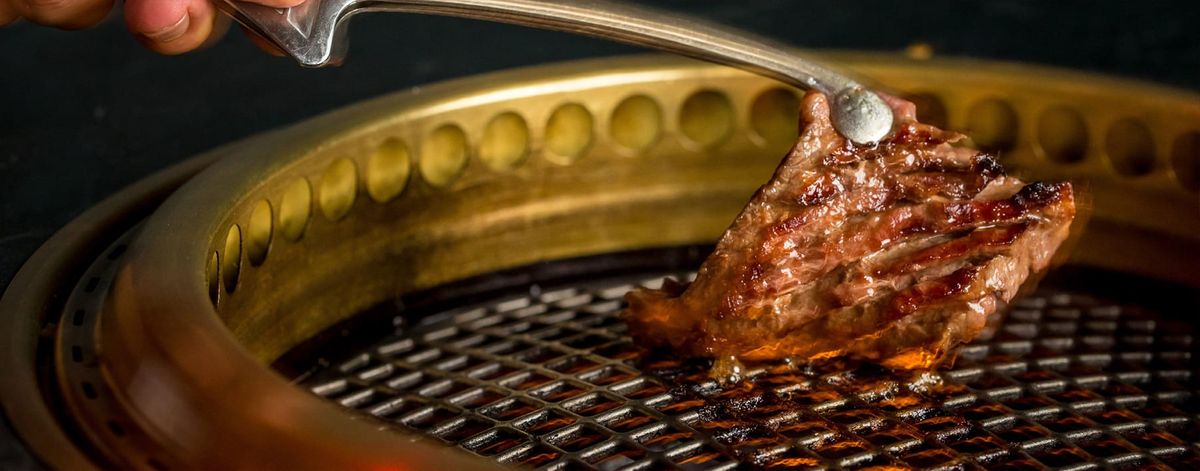 person grilling meats