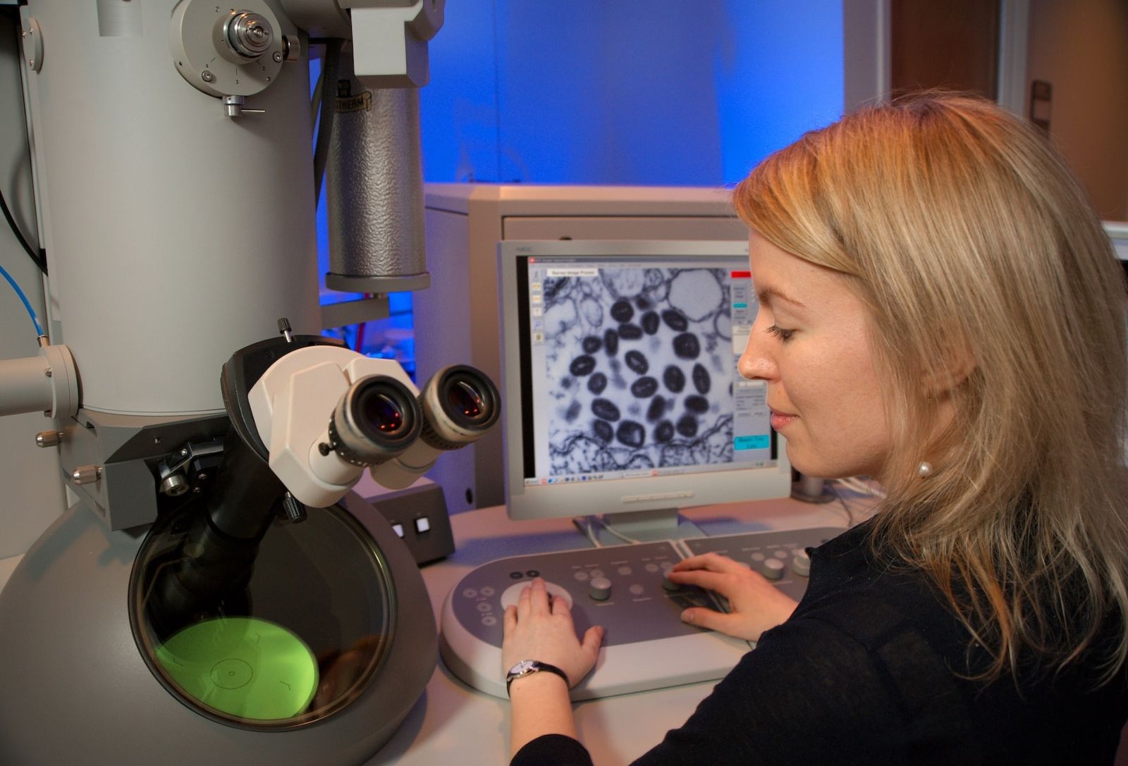 Woman using microscope