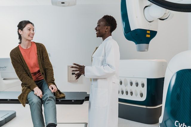 Two women standing in front of medical equipment