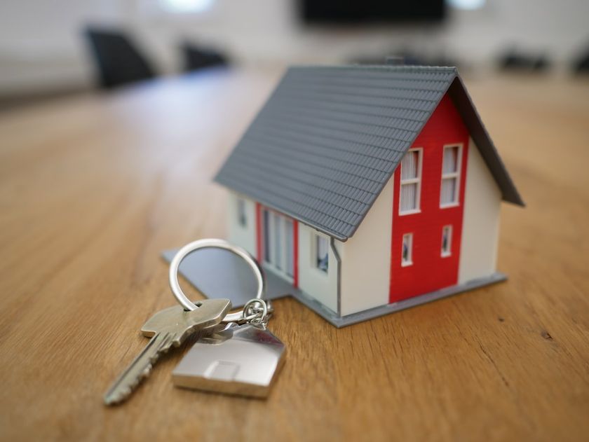 Miniature house with keychain besides it