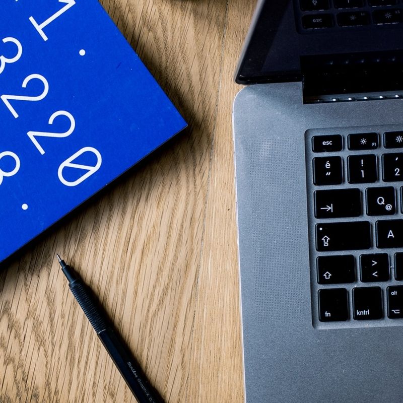 Computer, pen and notebook