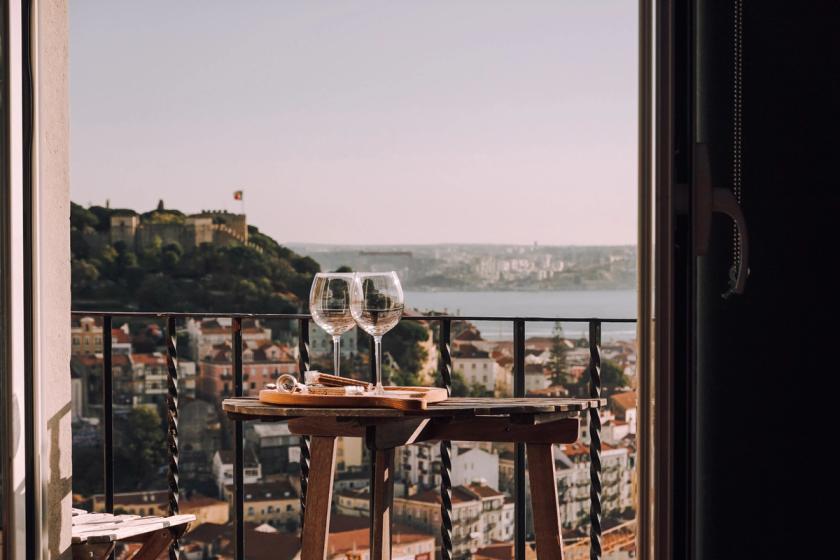 Empty wine classes on a balcony with view over Lisbon